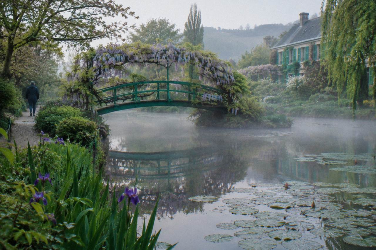 Water lily pond with the Japanese bridge covered in wisteria at Monet's garden in Giverny
