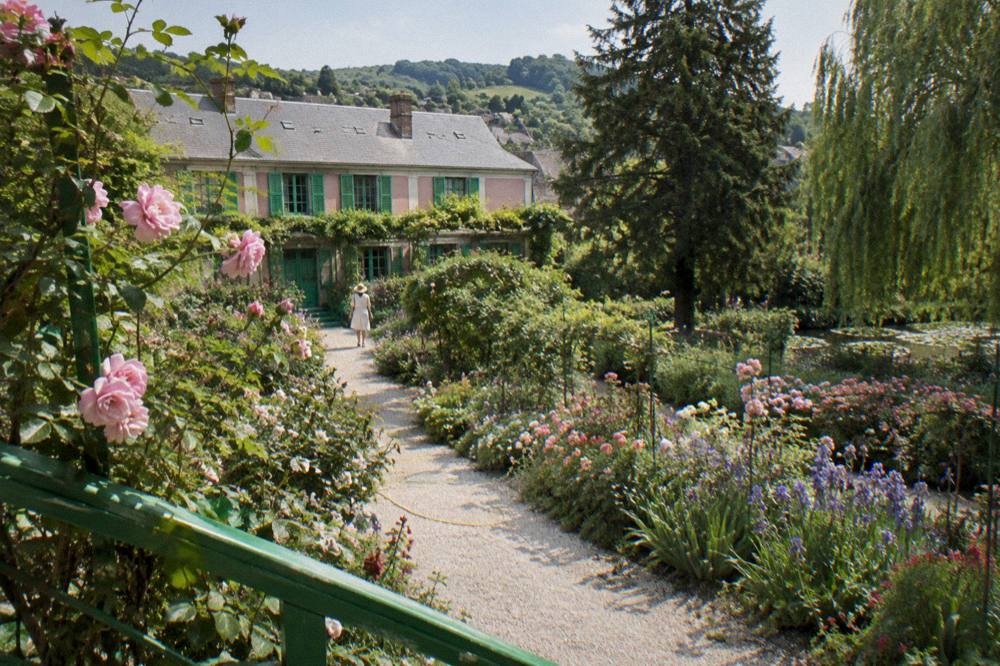 The flower garden path with Monet's pink house and green shutters in the background