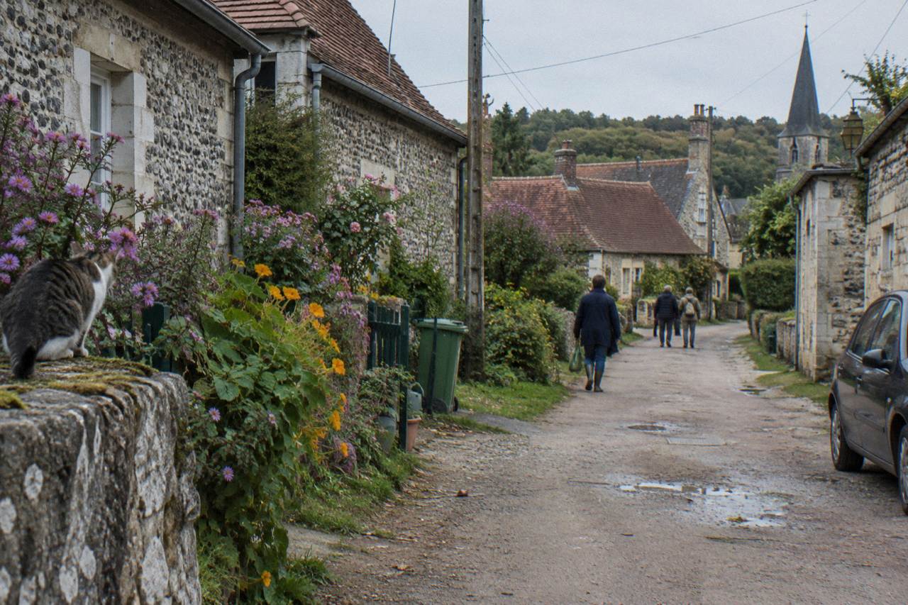 A quiet village lane in Giverny lined with stone cottages and flower gardens