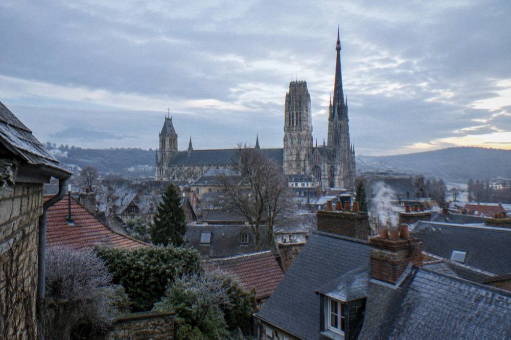 Gothic cathedral tower seen over rooftops in Rouen