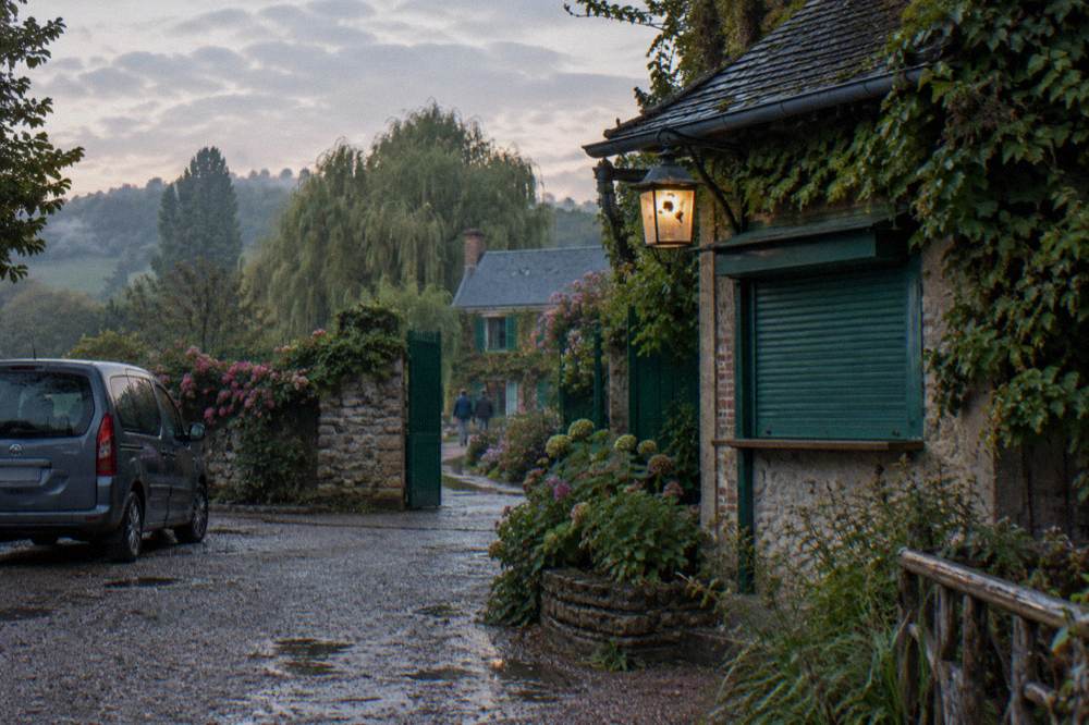 A small minivan parked on a lane near the entrance to Monet's garden in Giverny