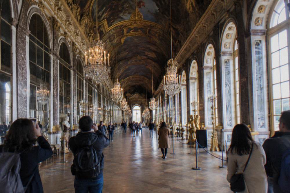 Hall of mirrors style gilded gallery interior at the Palace of Versailles