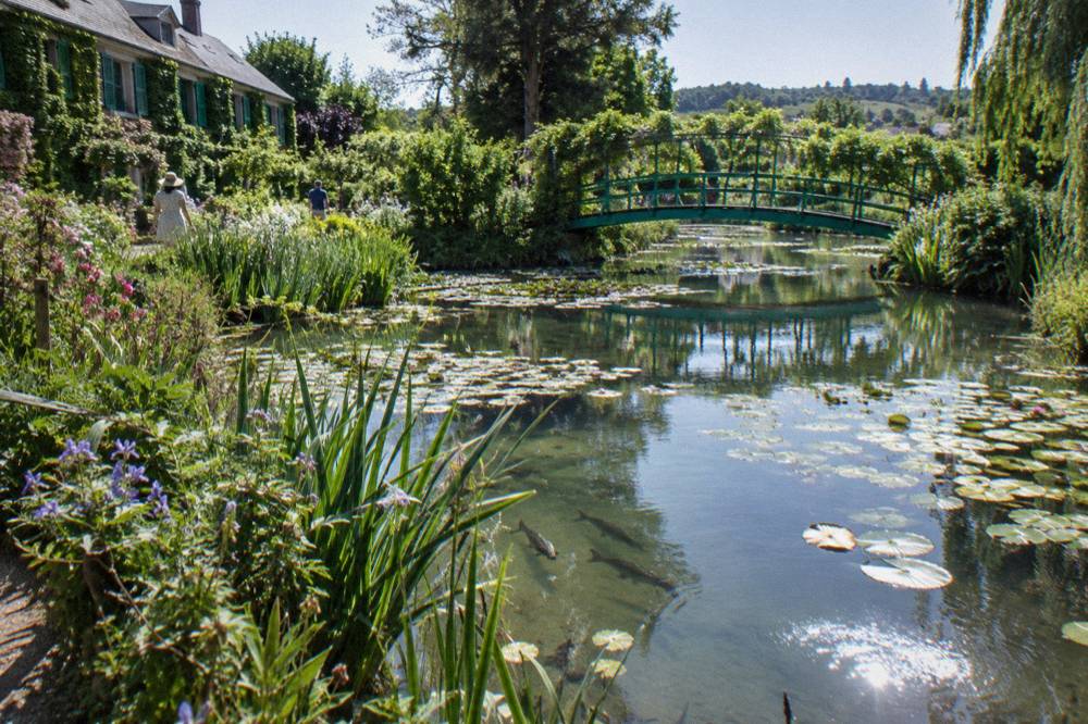 The green Japanese bridge crossing the water lily pond in Monet's garden