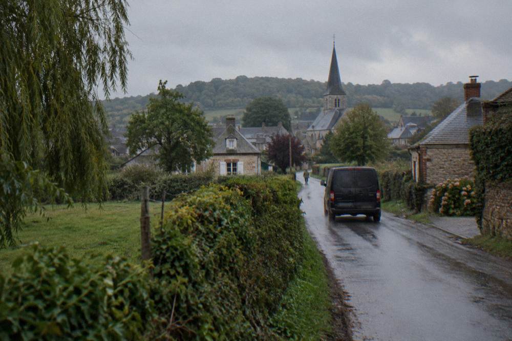 A private minivan on a country road between Giverny and Versailles with fields on both sides