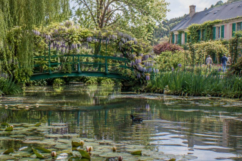 The green Japanese bridge over the water lily pond in Monet's garden at Giverny